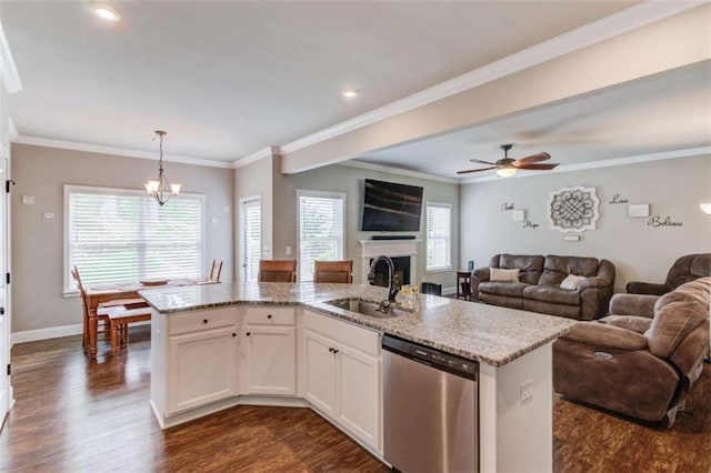 kitchen featuring sink, white cabinetry, hanging light fixtures, dishwasher, and an island with sink