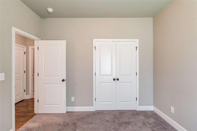 unfurnished bedroom featuring a closet and carpet