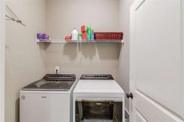 laundry area with washing machine and clothes dryer