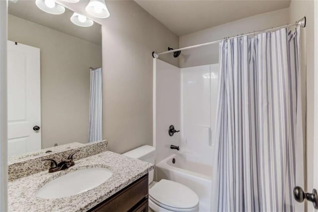 full bathroom featuring vanity, shower / bath combination with curtain, and toilet