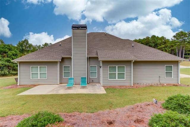 back of house with a patio area and a lawn