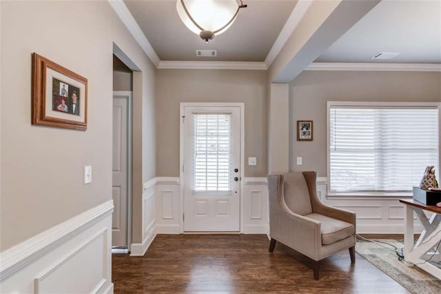 entryway with dark hardwood / wood-style flooring and ornamental molding