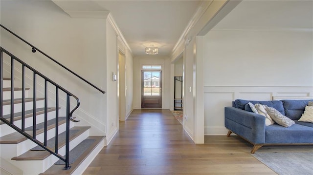 3173 Rockbridge Rd, Avondale Estates, GA 30002 - entrance foyer featuring wood finished floors, stairs, crown molding, baseboards, and a decorative wall