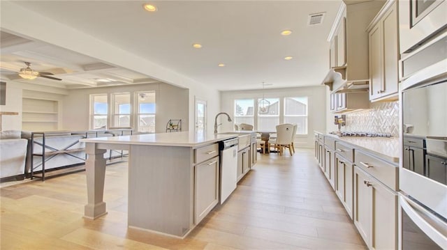 3173 Rockbridge Rd, Avondale Estates, GA 30002 - kitchen featuring appliances with stainless steel finishes, open floor plan, recessed lighting, light countertops, and light wood-type flooring