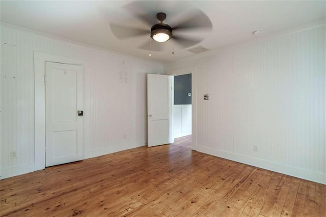 245 Alcovy St, Monroe, GA 30655 - empty room with hardwood / wood-style flooring, crown molding, and ceiling fan