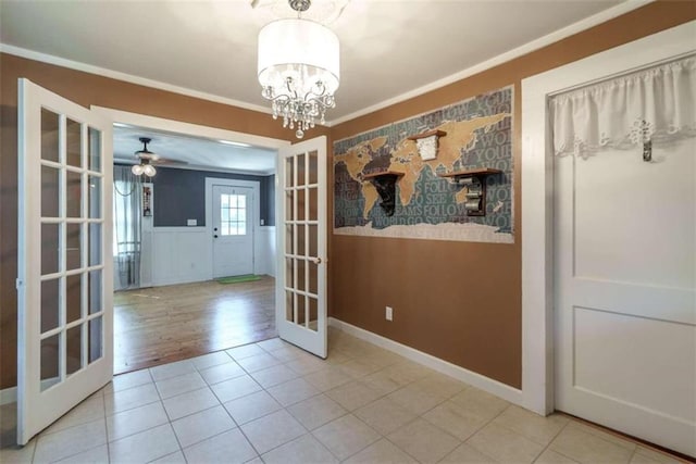 245 Alcovy St, Monroe, GA 30655 - unfurnished dining area featuring ceiling fan with notable chandelier, french doors, ornamental molding, and tile patterned flooring
