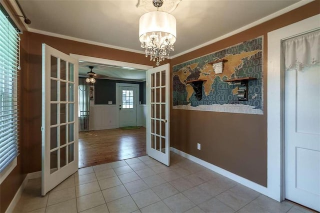 245 Alcovy St, Monroe, GA 30655 - unfurnished dining area with ceiling fan with notable chandelier, french doors, tile patterned floors, and crown molding