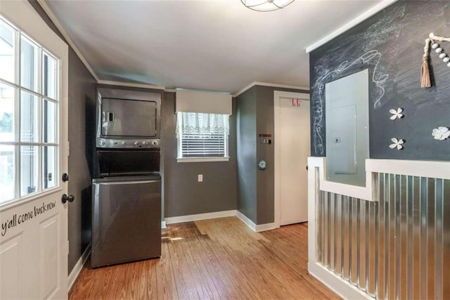 245 Alcovy St, Monroe, GA 30655 - kitchen featuring electric panel, stacked washer / drying machine, crown molding, and light hardwood / wood-style floors