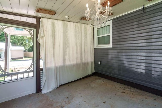 245 Alcovy St, Monroe, GA 30655 - unfurnished sunroom featuring a chandelier