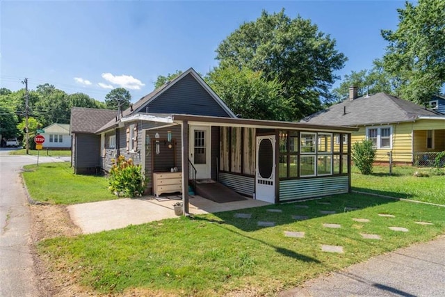 245 Alcovy St, Monroe, GA 30655 - rear view of house with a yard and a sunroom