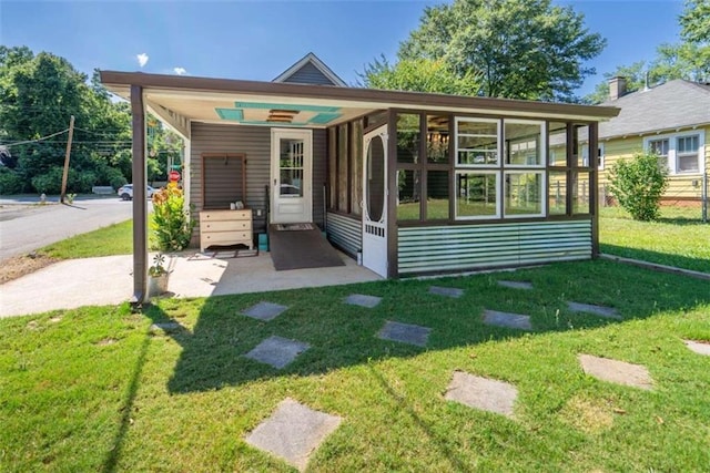 245 Alcovy St, Monroe, GA 30655 - rear view of house with a sunroom and a yard
