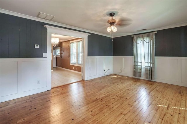 245 Alcovy St, Monroe, GA 30655 - spare room with light hardwood / wood-style floors, ornamental molding, and ceiling fan with notable chandelier