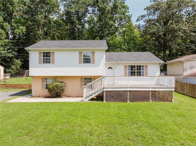 view of front of house with a wooden deck and a front lawn