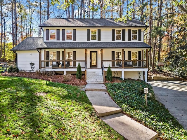 view of front of house featuring covered porch and a front yard