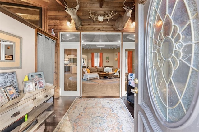 interior space with dark hardwood / wood-style floors and rustic walls