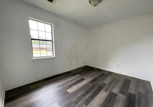 empty room featuring dark wood-type flooring