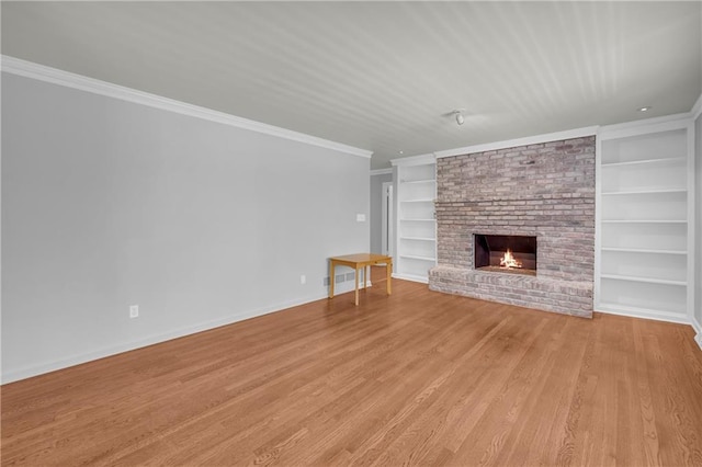 4331 E Kings Point Cir, Dunwoody, GA 30338 - unfurnished living room with built in shelves, a fireplace, ornamental molding, light wood-type flooring, and baseboards
