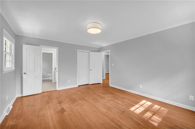 4331 E Kings Point Cir, Dunwoody, GA 30338 - unfurnished bedroom with baseboards, light wood finished floors, ornamental molding, and ensuite bathroom