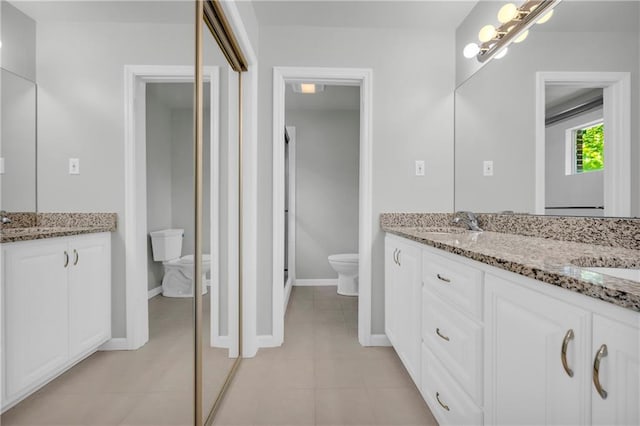 4331 E Kings Point Cir, Dunwoody, GA 30338 - bathroom with toilet, double vanity, tile patterned floors, and baseboards