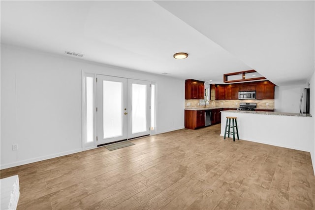 4331 E Kings Point Cir, Dunwoody, GA 30338 - unfurnished living room with light wood finished floors, baseboards, and french doors