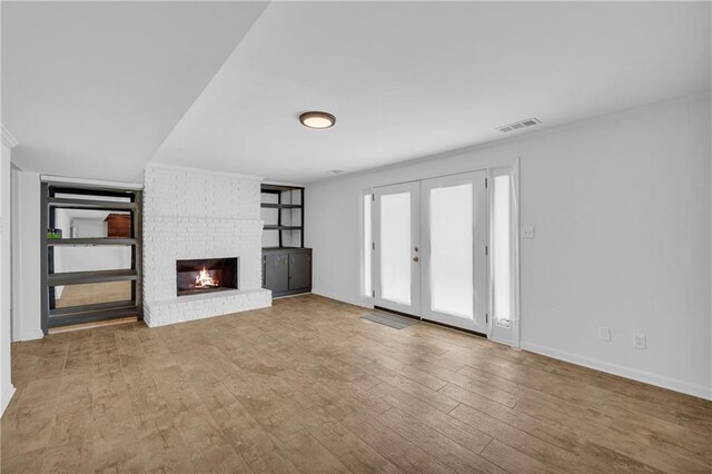 4331 E Kings Point Cir, Dunwoody, GA 30338 - unfurnished living room with a fireplace, wood finished floors, and baseboards