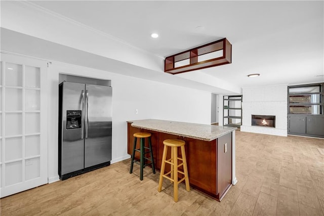 4331 E Kings Point Cir, Dunwoody, GA 30338 - kitchen featuring stainless steel refrigerator with ice dispenser, a peninsula, light wood finished floors, light stone counters, and recessed lighting