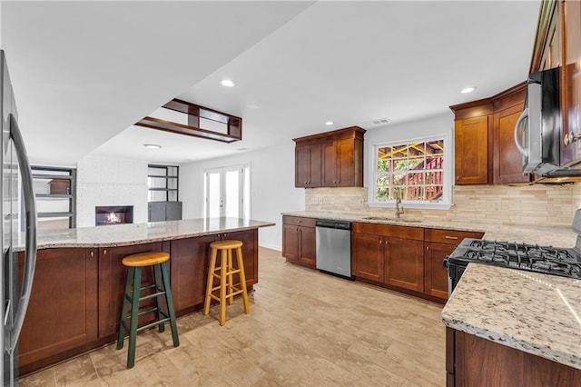 4331 E Kings Point Cir, Dunwoody, GA 30338 - kitchen featuring stainless steel appliances, a sink, healthy amount of natural light, light stone countertops, and recessed lighting