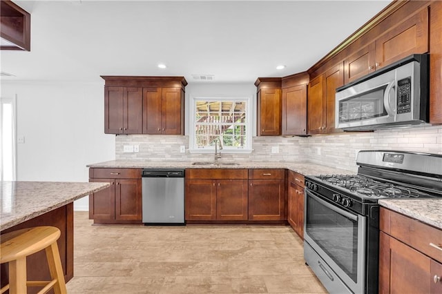 4331 E Kings Point Cir, Dunwoody, GA 30338 - kitchen featuring appliances with stainless steel finishes, a sink, light stone counters, tasteful backsplash, and recessed lighting