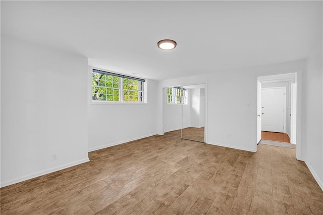 4331 E Kings Point Cir, Dunwoody, GA 30338 - unfurnished bedroom with light wood finished floors, baseboards, and a closet