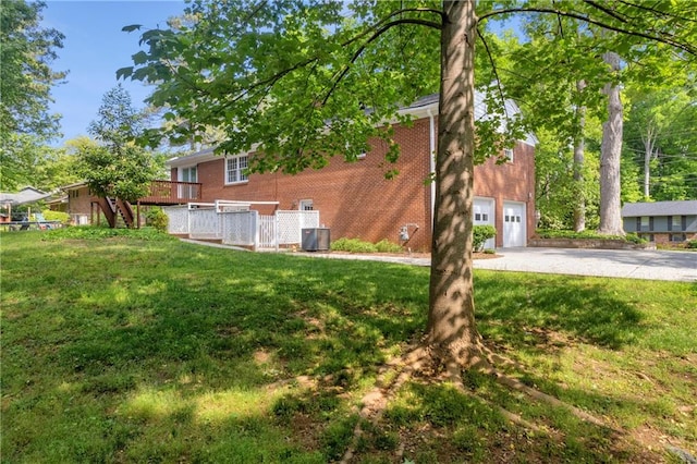 4331 E Kings Point Cir, Dunwoody, GA 30338 - view of green lawn with central AC, driveway, a garage, and stairs