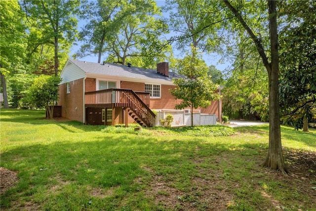 4331 E Kings Point Cir, Dunwoody, GA 30338 - back of house with stairs, a wooden deck, a chimney, brick siding, and a lawn