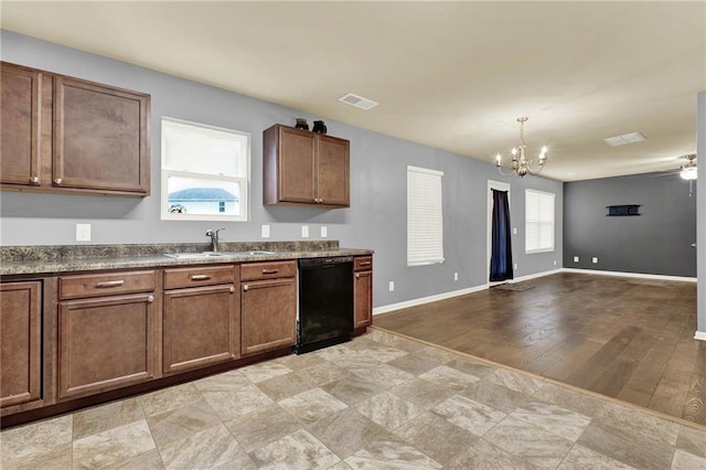 kitchen with ceiling fan with notable chandelier, sink, pendant lighting, light hardwood / wood-style flooring, and black dishwasher