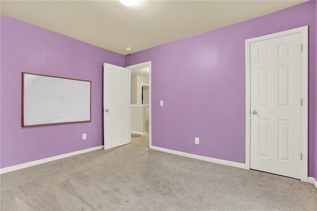 unfurnished bedroom with light colored carpet