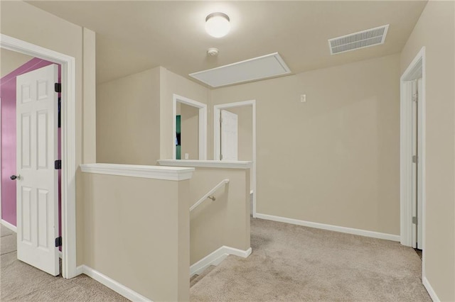 hallway with light colored carpet