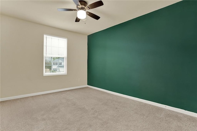 empty room featuring carpet flooring and ceiling fan