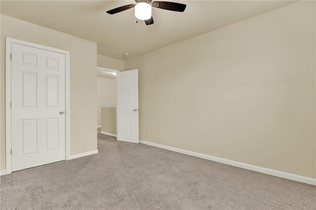 unfurnished bedroom featuring light colored carpet and ceiling fan