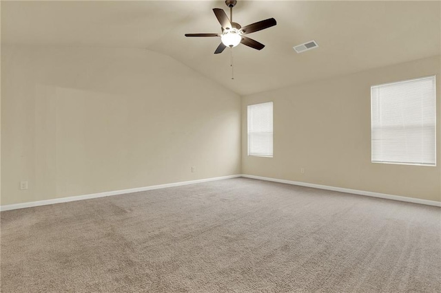 carpeted spare room with vaulted ceiling and ceiling fan