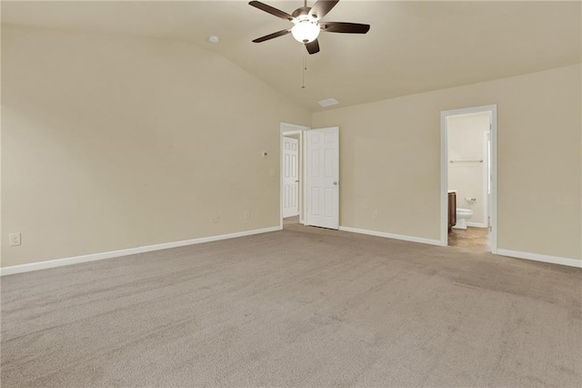 unfurnished room with ceiling fan, lofted ceiling, and light carpet