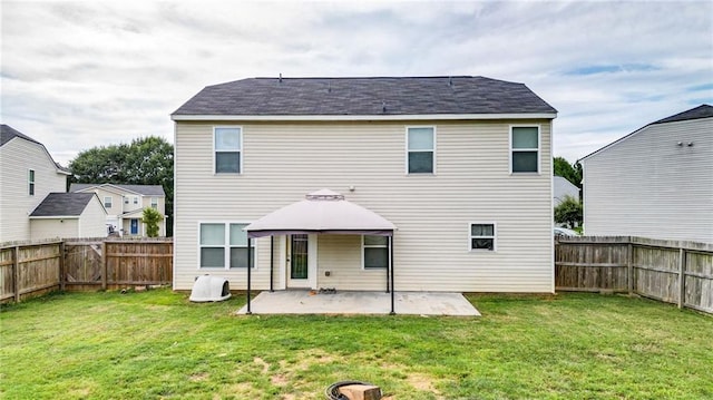 rear view of house featuring a gazebo, a patio area, and a lawn