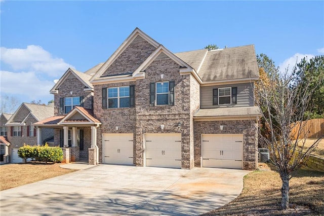 craftsman inspired home featuring a garage and cooling unit