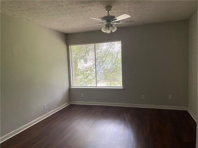 spare room with ceiling fan, a wealth of natural light, hardwood / wood-style flooring, and a textured ceiling