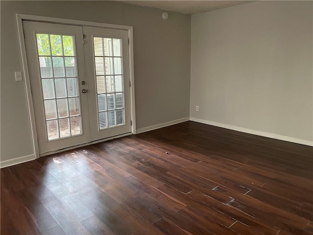 unfurnished room with dark wood-type flooring and french doors