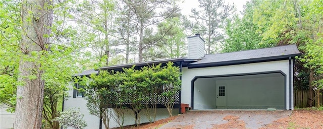 exterior space with driveway and an attached garage