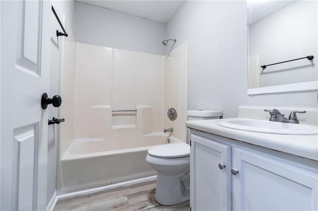 full bath with vanity, wood finished floors, bathtub / shower combination, and toilet