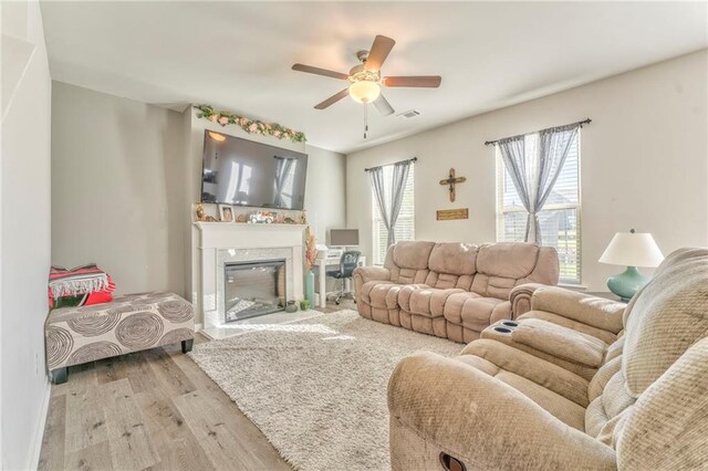 living room with ceiling fan and light hardwood / wood-style floors