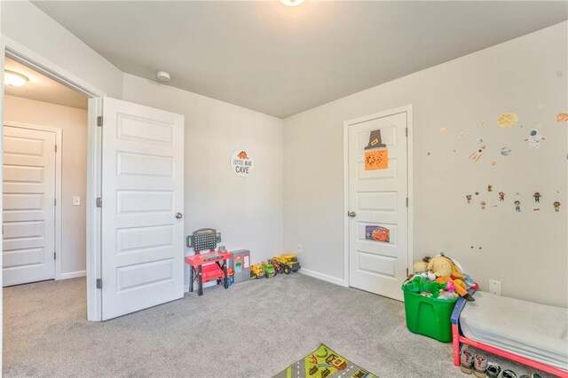 game room featuring light carpet