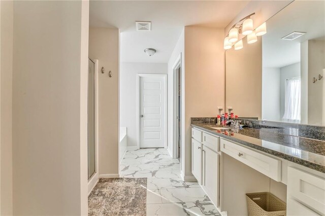 bathroom featuring vanity and independent shower and bath