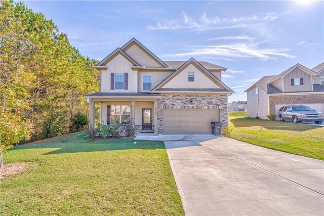 craftsman inspired home featuring a garage and a front lawn