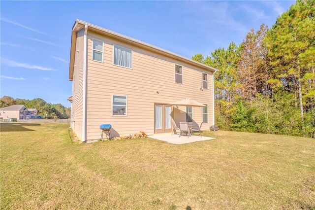 back of house featuring a patio area and a yard