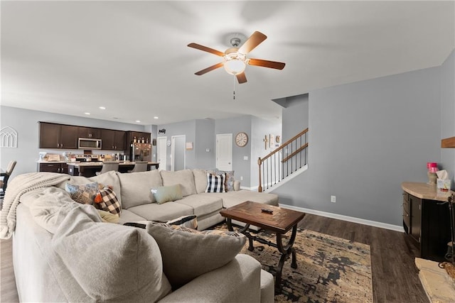 living room featuring ceiling fan, stairs, recessed lighting, baseboards, and dark wood-type flooring